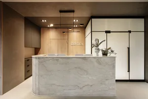 A modern office reception desk crafted from stone with a sleek, minimalist design.