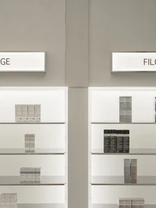 Modern, minimalist shelves displaying products in a retail environment.