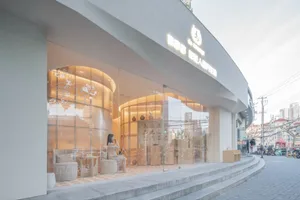 A modern retail storefront with glass walls and a minimalist design aesthetic.