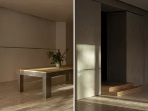 Minimalist interior design featuring a concrete table with a plant on it, showcasing a sleek, modern aesthetic.