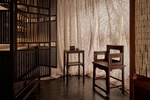 A minimalist interior featuring wooden furniture and a simple, elegant design.