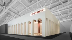 A modern interior space featuring white concrete columns against a white background.