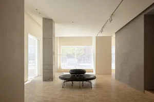 Modern lobby space featuring a black circular seating area and white walls.