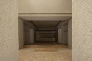 A minimalist concrete entrance with a wooden floor and minimalist design elements.