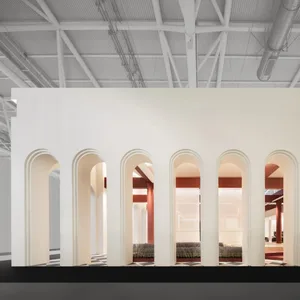 A modern office interior with concrete walls and arches.