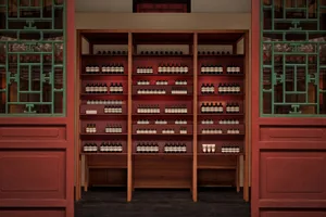 Modern retail storefront featuring wooden shelves stocked with products.