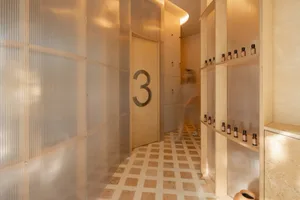A modern spa treatment room with marble floors and veneer walls.