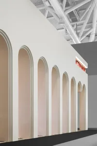 Neutral-colored retail interior with arches and lighting pipes