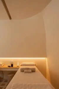Neutral-colored spa room with minimalist design features and soft lighting.