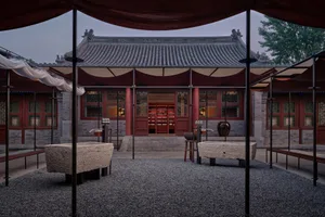 Stone and wood traditional Chinese building with glass windows