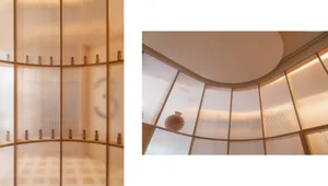 A modern storefront display featuring glass and brass elements.