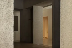 Modern minimalist interior with concrete walls and floor.