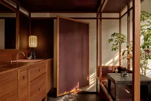 A modern bathroom featuring wooden paneling and a sink with a faucet.