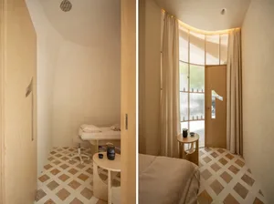 A modern hotel suite featuring wooden furniture and flooring.