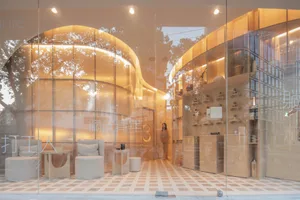 A modern retail storefront with glass walls and interior design features