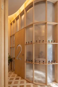 A spa interior featuring a wooden shelf with small bottles.