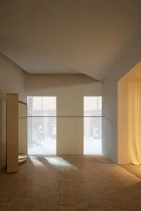 Minimalist interior design featuring wooden furniture, glass windows, and concrete walls