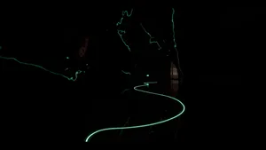 A minimalistic tunnel with a winding electric light guiding the way