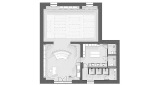 Industrial-style office layout with a workspace, meeting area, and ancillary spaces.