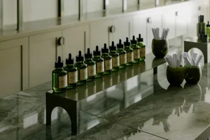 Industrial-style workplace with a row of green glass bottles.