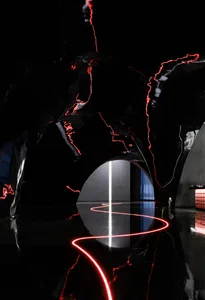 A minimalist black cave with glass and metal elements.