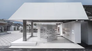 A minimalist retail storefront featuring transparent glass walls and a modern minimalist design.