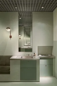 Modern bathroom featuring tiled walls and concrete fixtures