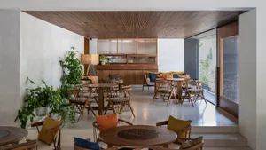 A modern cafe featuring marble and wooden furniture and design elements.