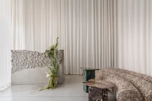 Modern storefront made of concrete with greenery.
