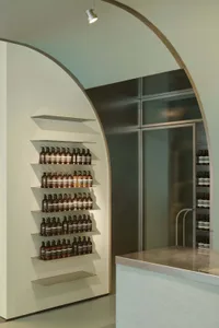 Modern storefront interior with metal shelves and glass walls