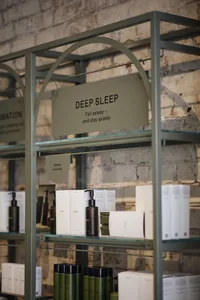 A display of sleep products on glass shelves in a modern interior setting.