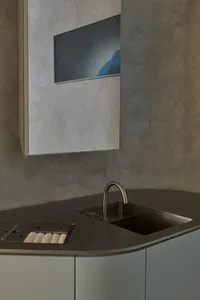 Modern kitchen featuring a concrete countertop and minimalist design.