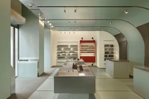 A modern retail storefront featuring concrete elements and a minimalist design.