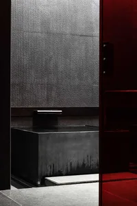 Concrete bathtub and shower enclosure in an industrial-style bathroom