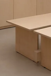 A table with wooden legs and a wood grain finish.