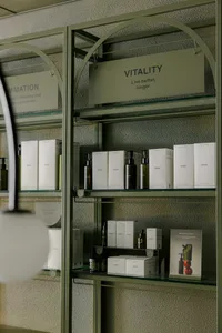 Modern, sleek product display shelf with metal framing and glass shelves.