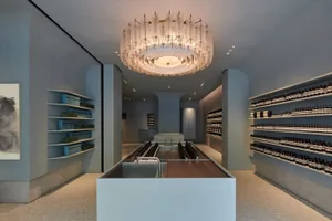Modern retail store with glass ceiling and shelves.