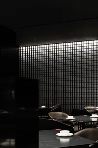 Minimalist restaurant interior with black and glass design elements.