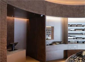 Modern retail storefront featuring timber paneled walls and a sleek counter with a computer monitor.