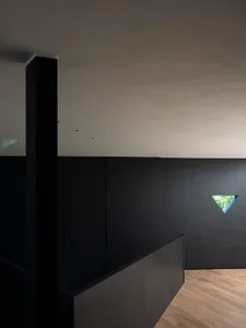 A minimalist black interior with a metallic window