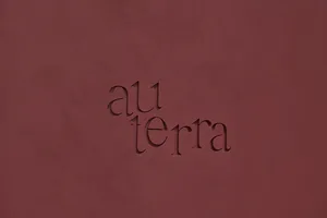 Textured surface featuring the word 'au terra' in minimalist branding design.