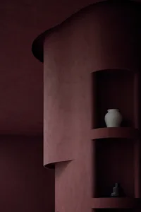 Concrete shelving unit with minimalist decor in a modern interior setting.