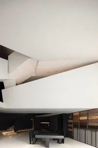 Minimalist interior design featuring white walls and mixed materials.