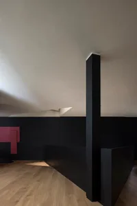 A modern interior space featuring concrete walls, minimalist design, and geometric shapes.