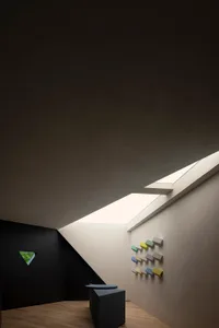A modern, minimalist architectural space with concrete walls and a skylight.