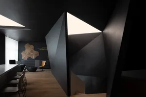 An office space featuring a contemporary design with dark metallic elements.