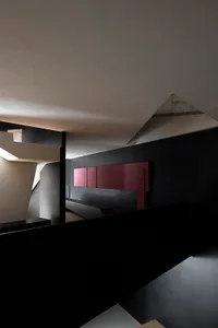 A modern staircase with minimalist black steel railings and mixed-material elements.
