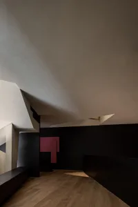 An interior space with geometric shapes and contrasting black and white colors