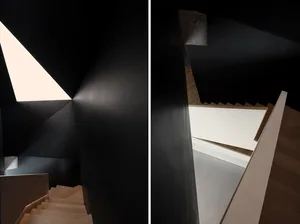 Modern staircase with concrete walls and wooden steps, featuring a 45-degree angle.