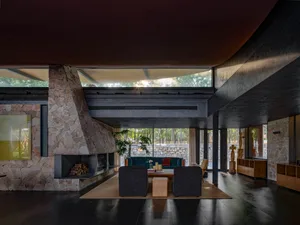 A modern living room with concrete walls and stone flooring.